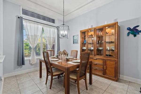 a dining room with furniture a chandelier and window