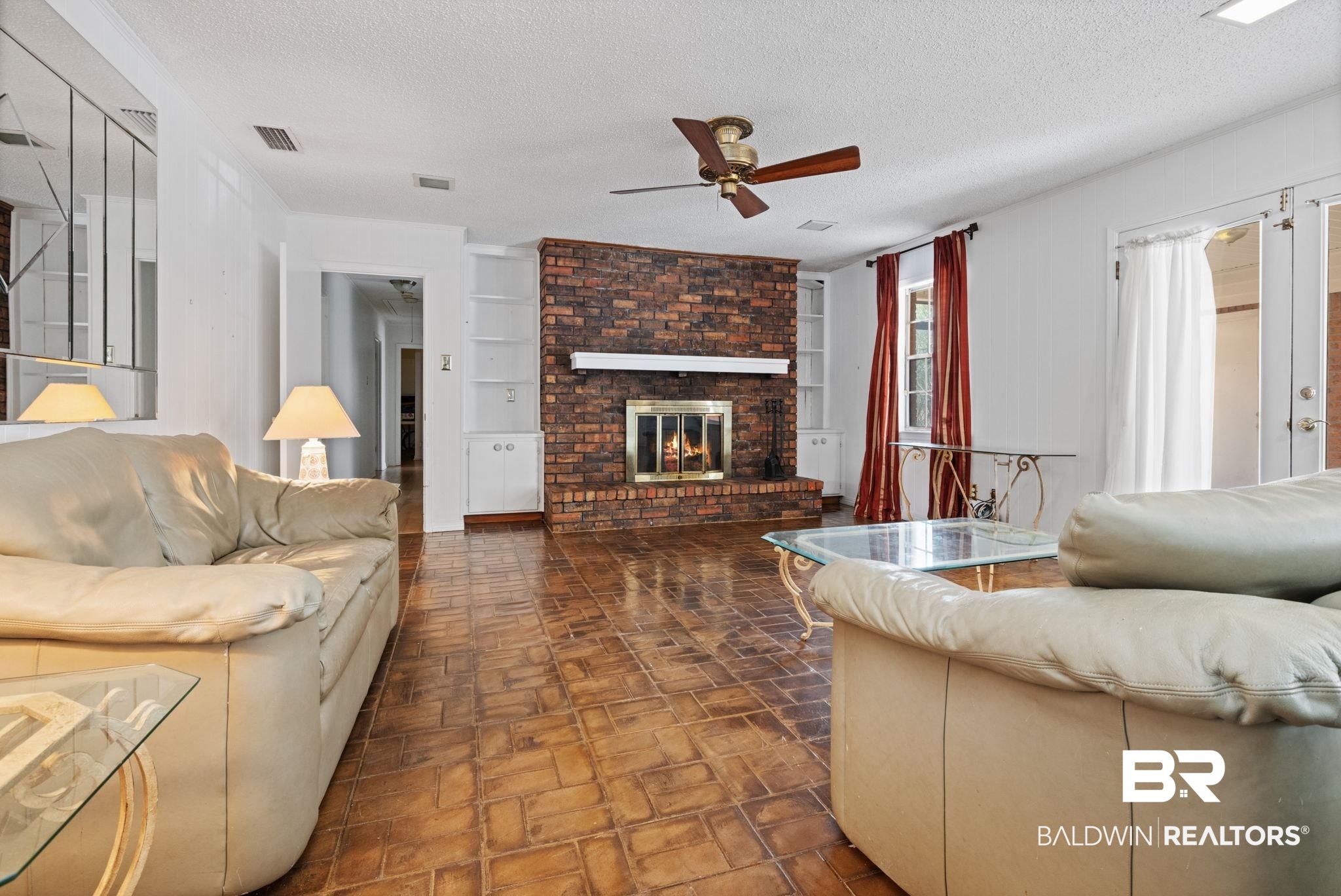 6261 Old Pascagoula Road Theodore, AL 36582 - Photo 13 of 29 Living room featuring ceiling fan, a fireplace, and a textured ceiling