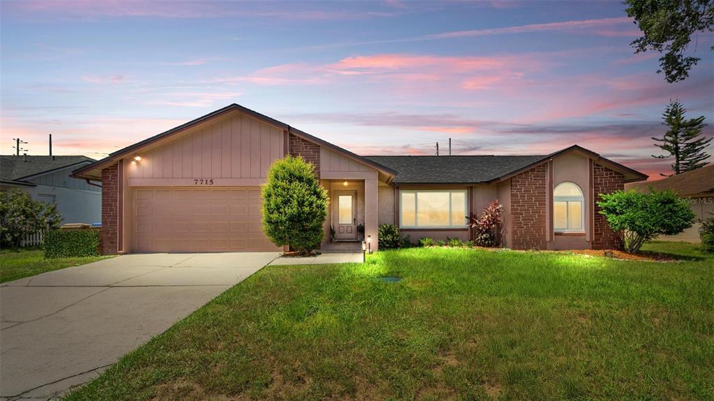 7715 Indian Ridge Trail North Kissimmee, FL 34747 - Photo 1 of 1 a front view of a house with a yard and garage