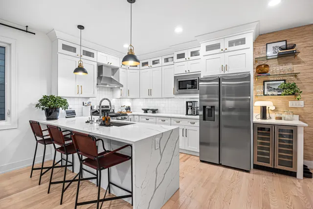 a living room with fireplace furniture and a large window