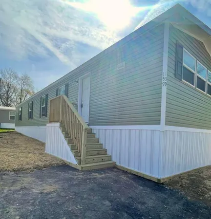 a view of a house with backyard and wooden fence