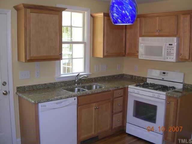 1826 Watkins Street Raleigh, NC 27604 - Photo 4 of 9 a kitchen with stainless steel appliances granite countertop a sink stove and cabinets