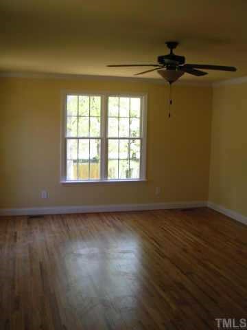 1826 Watkins Street Raleigh, NC 27604 - Photo 6 of 9 an empty room with wooden floor fan and windows