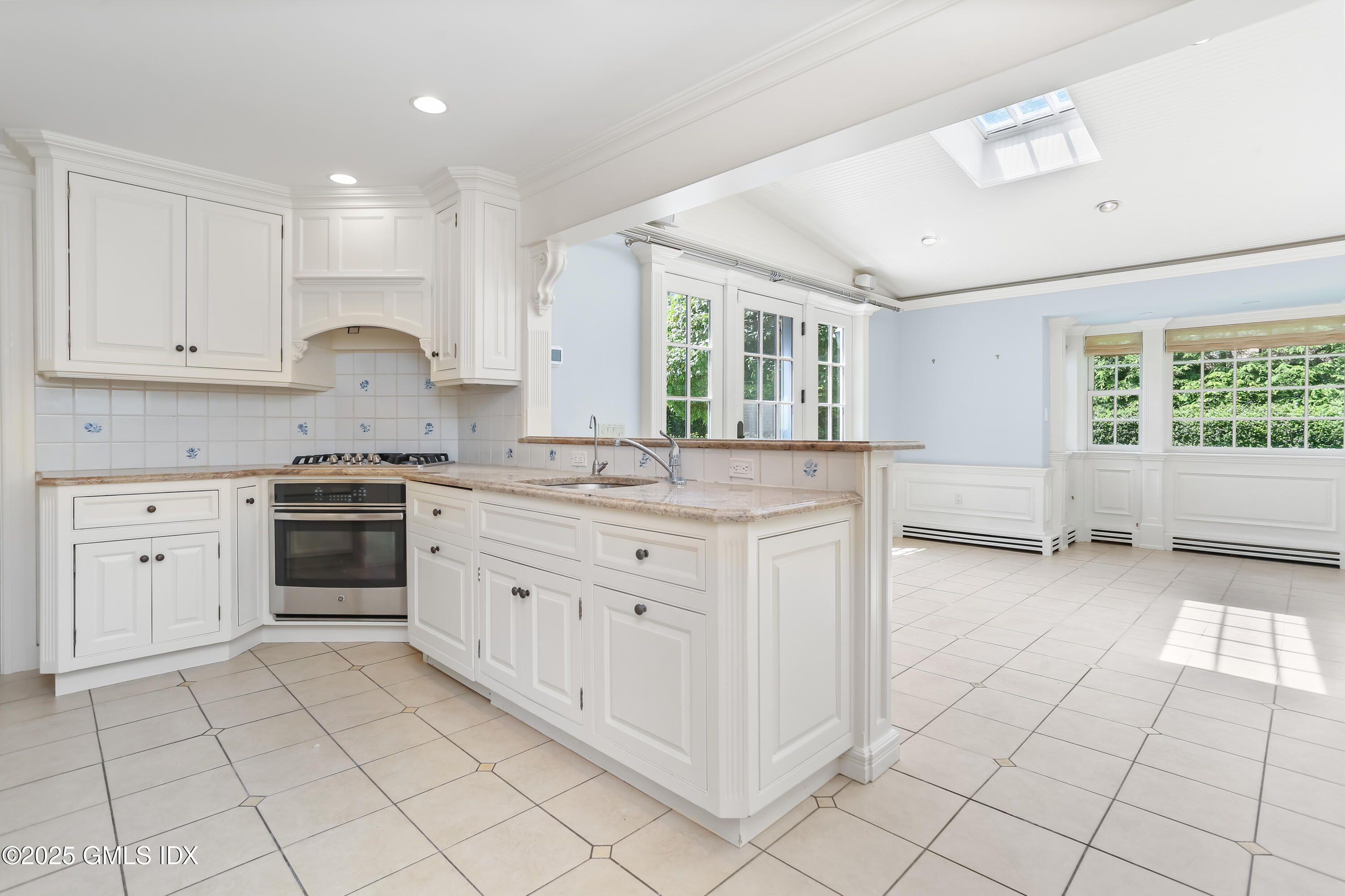 47 Winthrop Drive Riverside, CT 06878 - Photo 13 of 32 a kitchen with granite countertop white cabinets and white appliances