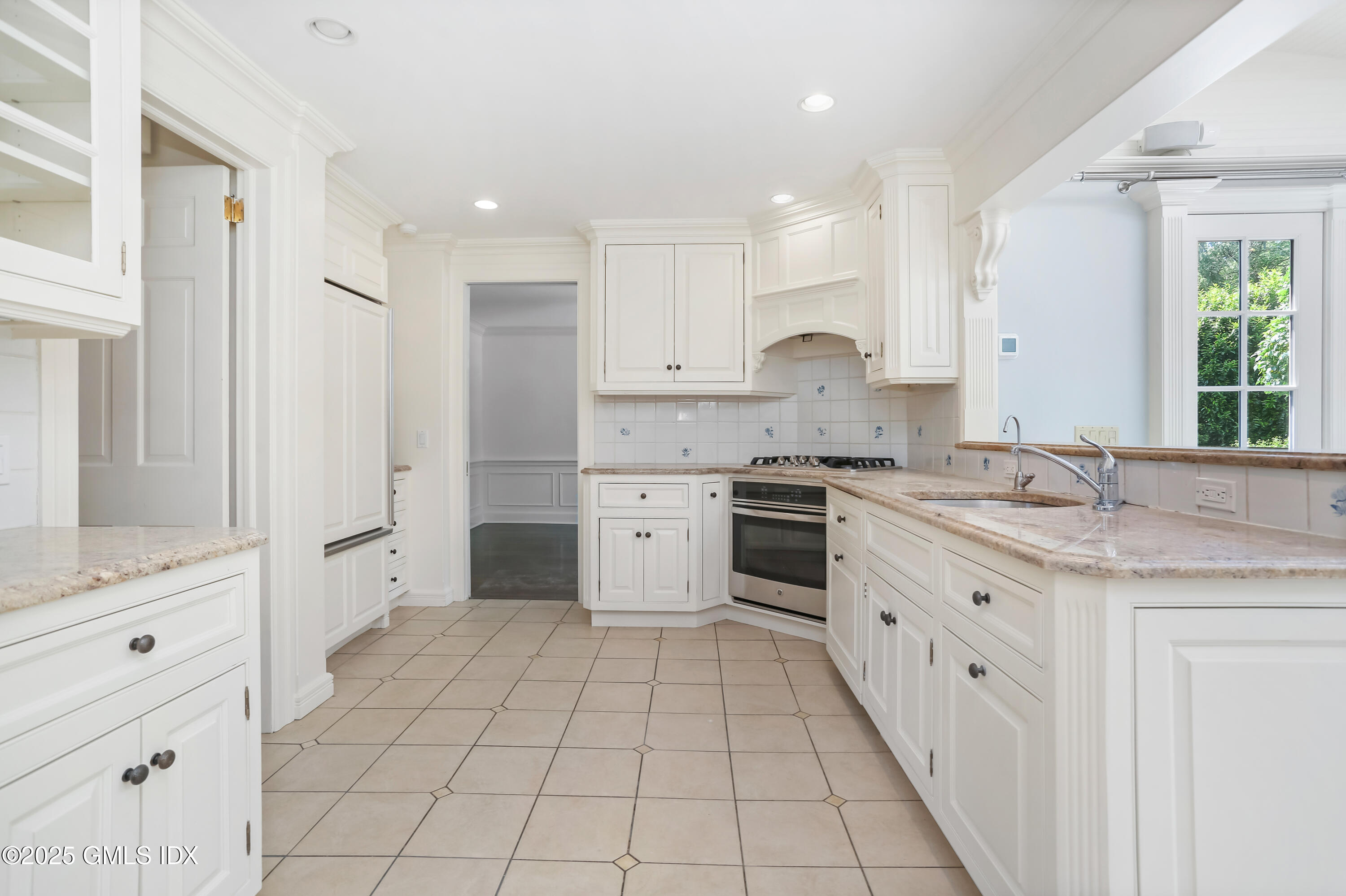47 Winthrop Drive Riverside, CT 06878 - Photo 14 of 32 a kitchen with granite countertop a sink stove and cabinets