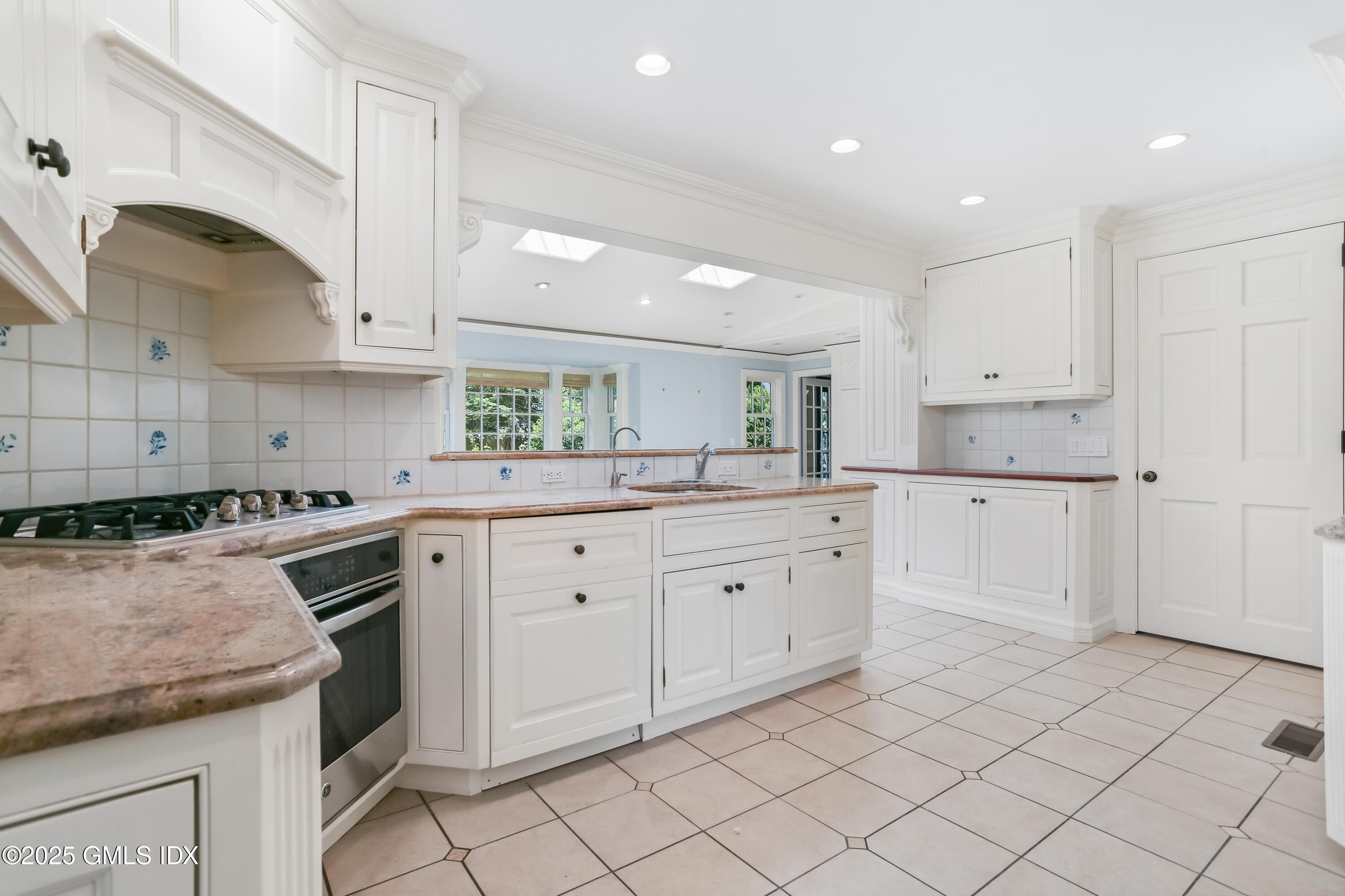 47 Winthrop Drive Riverside, CT 06878 - Photo 15 of 32 a kitchen with white cabinets appliances and a sink