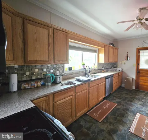 a kitchen with stainless steel appliances granite countertop a sink stove and microwave