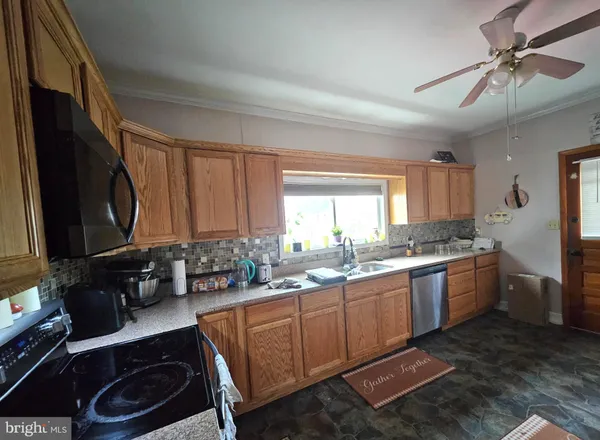 a room with a window furniture and a lamp