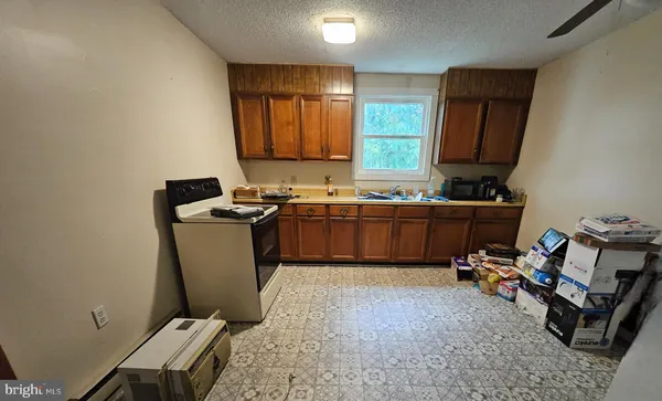 a view of a kitchen with a sink washer and dryer