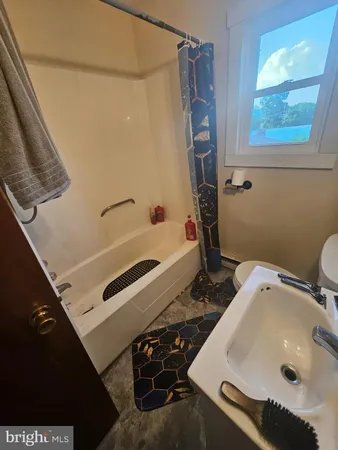 an empty room with windows and cabinet