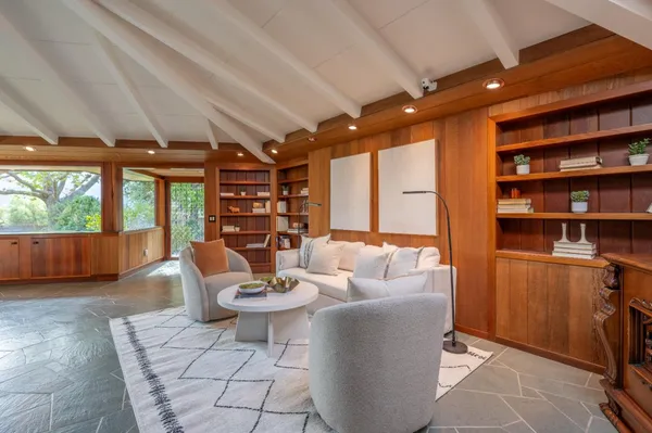 a living room with patio fireplace furniture and a fireplace