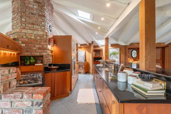 a kitchen with stainless steel appliances a stove and a dining table