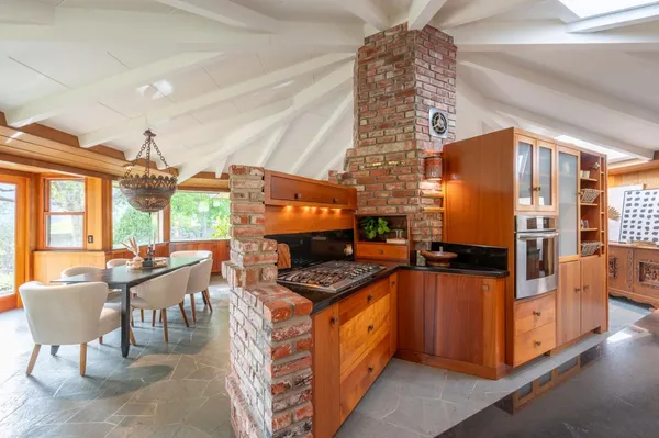 a kitchen with sink and large window