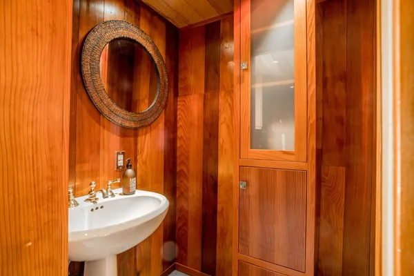 a view of hallway with a large window and wooden floor