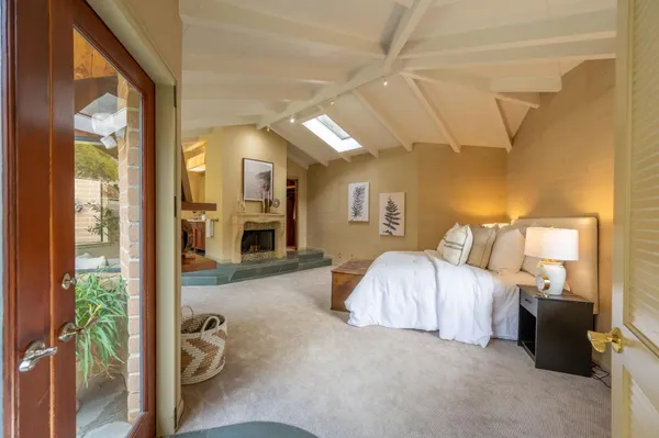 a spacious bedroom with a bed a couch and dresser