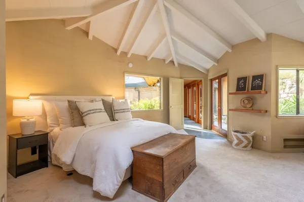 a large kitchen with kitchen island a large window in it