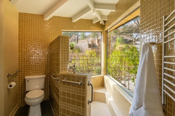 a bathroom with a glass door shower and a sink