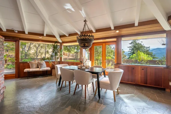 a dining room with furniture a chandelier and a rug