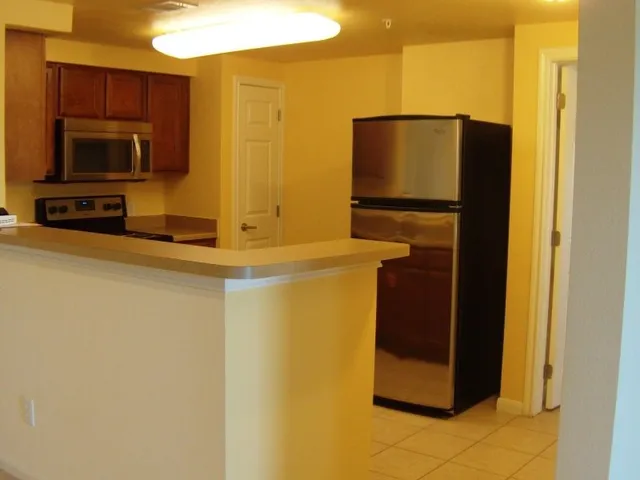 a kitchen with a refrigerator and a microwave