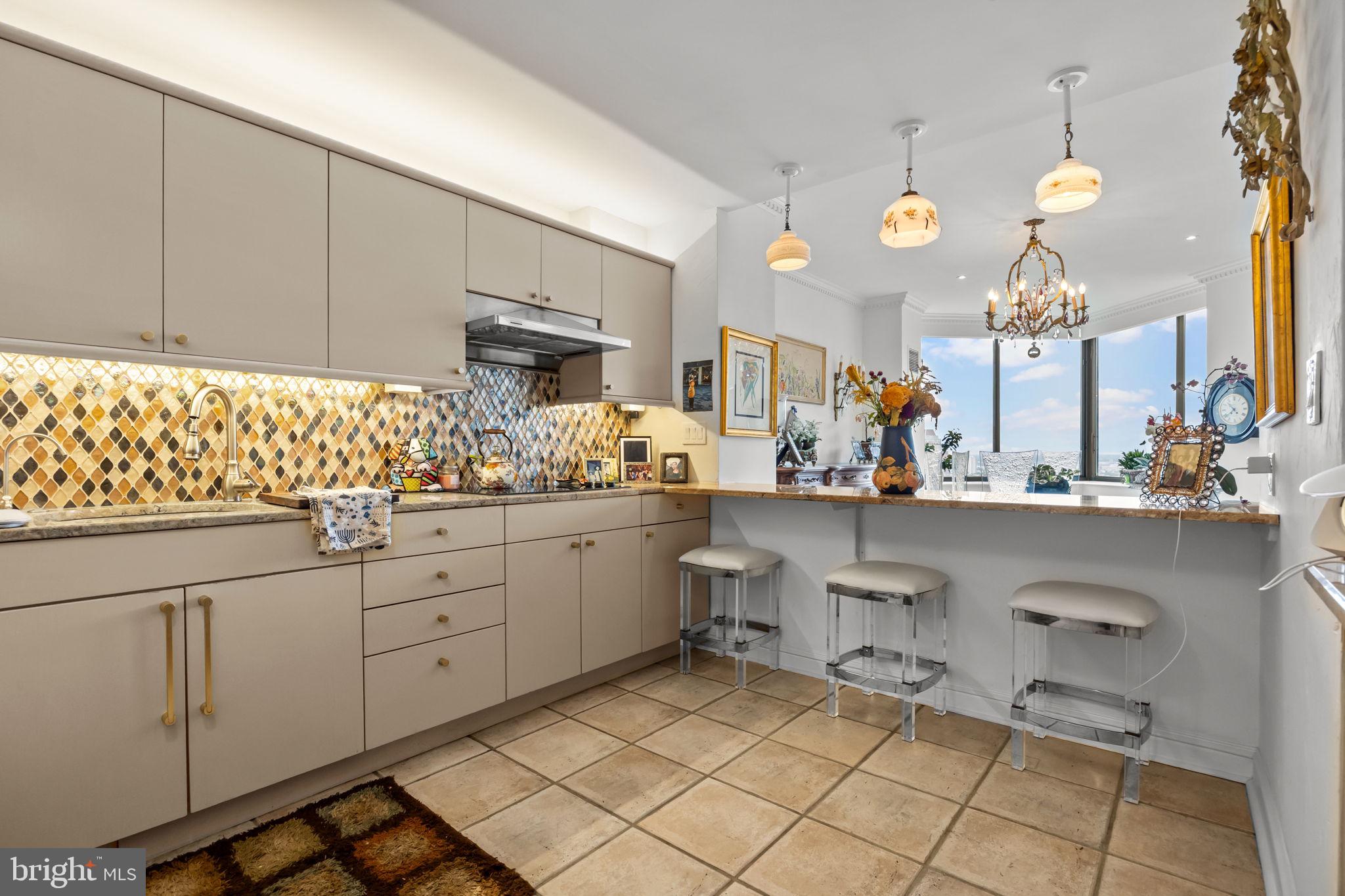 202 West Rittenhouse Square, Unit 2608 Philadelphia, PA 19103 - Photo 12 of 35 a kitchen with cabinets and chairs