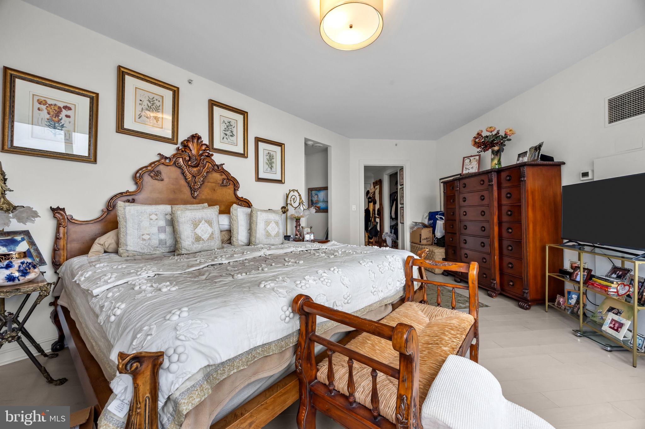 202 West Rittenhouse Square, Unit 2608 Philadelphia, PA 19103 - Photo 17 of 35 a bedroom with a bed and a flat screen tv