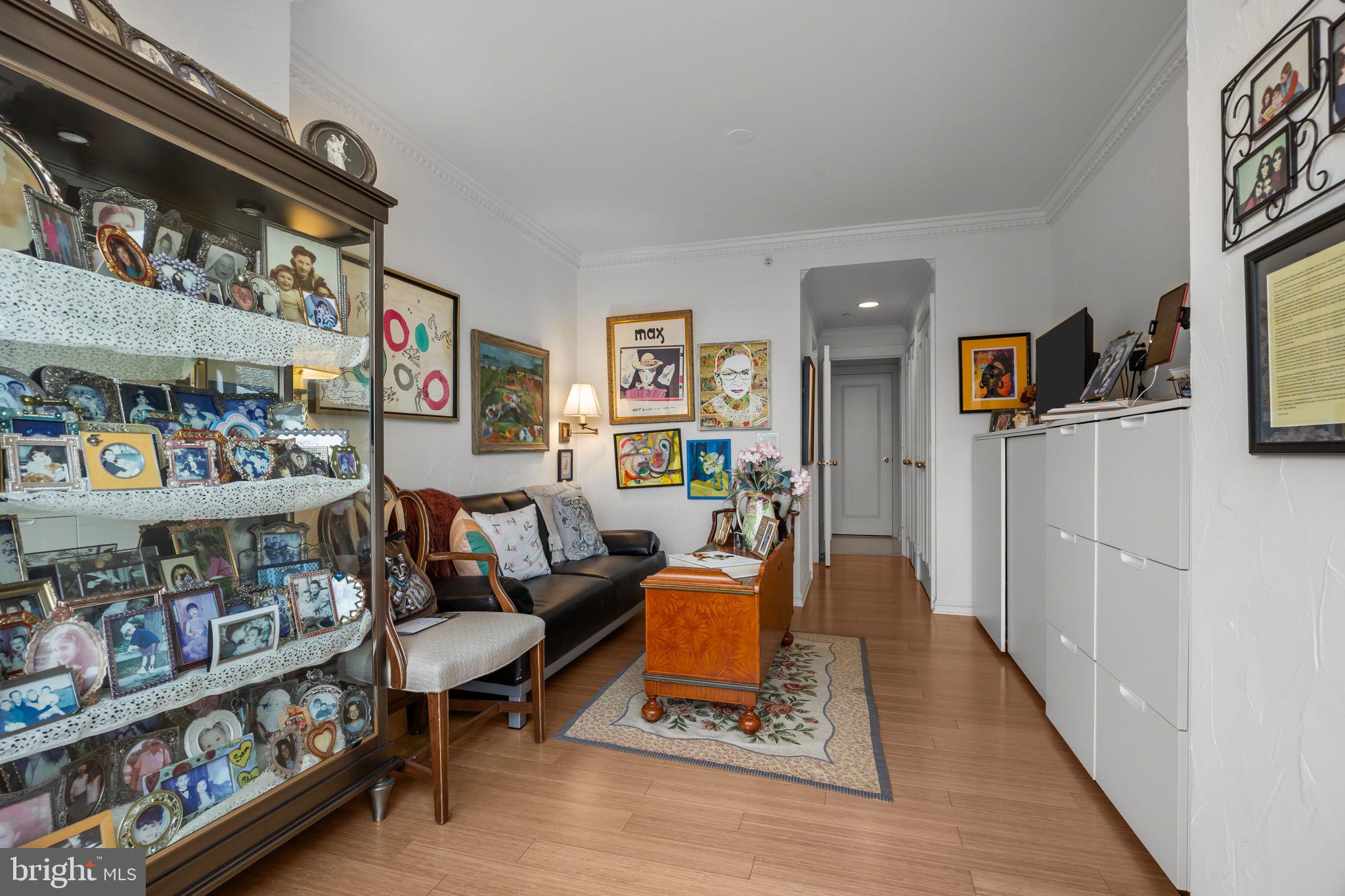 202 West Rittenhouse Square, Unit 2608 Philadelphia, PA 19103 - Photo 20 of 35 a living room with furniture and a book shelf