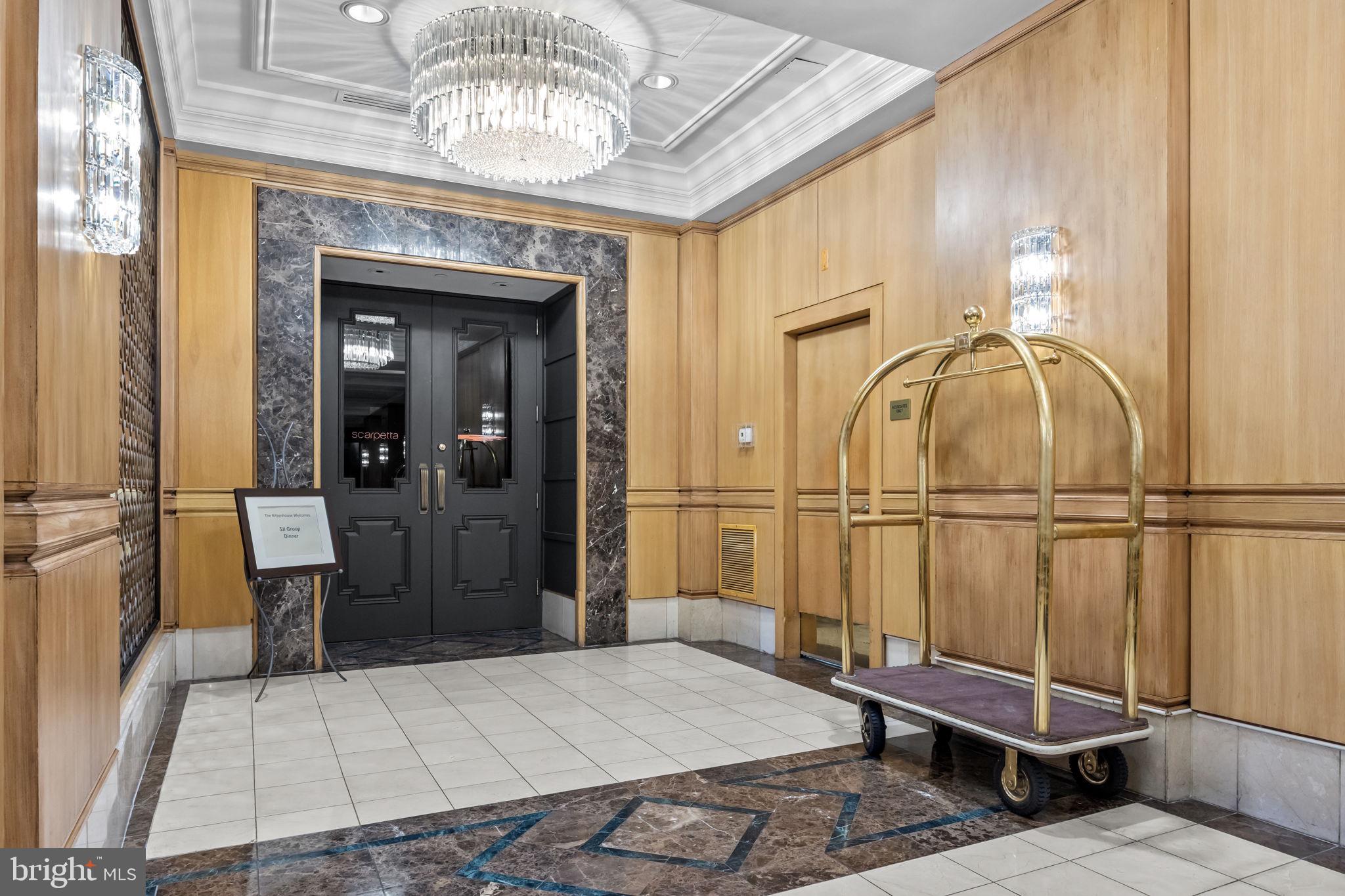 202 West Rittenhouse Square, Unit 2608 Philadelphia, PA 19103 - Photo 33 of 35 a bedroom with a bed and a chandelier