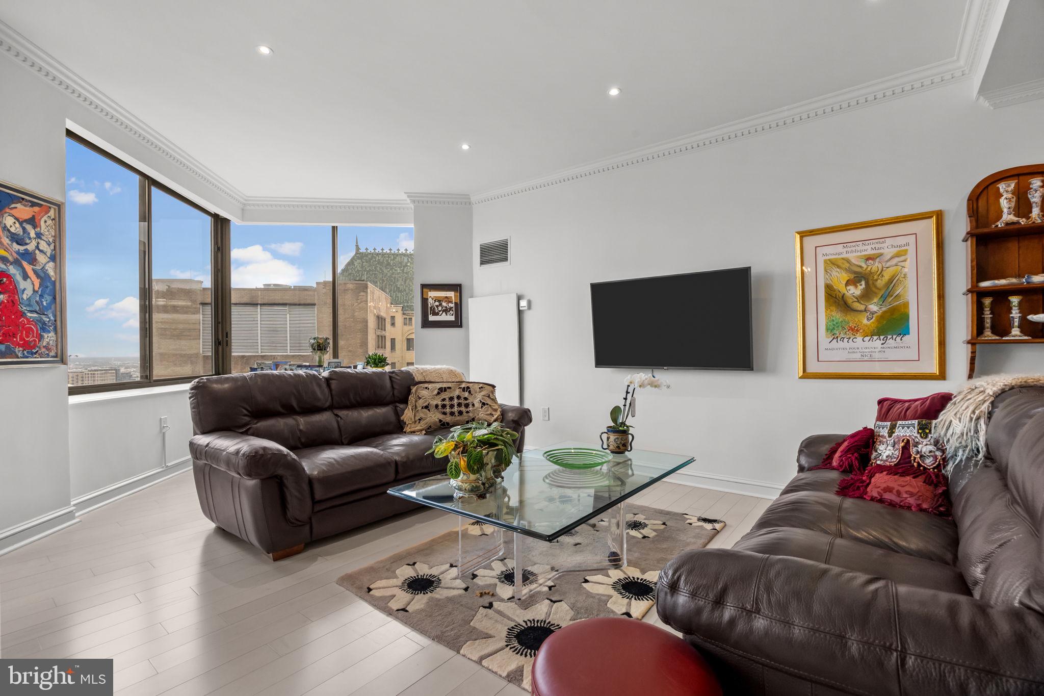 202 West Rittenhouse Square, Unit 2608 Philadelphia, PA 19103 - Photo 5 of 35 a living room with furniture flat screen tv and a large window