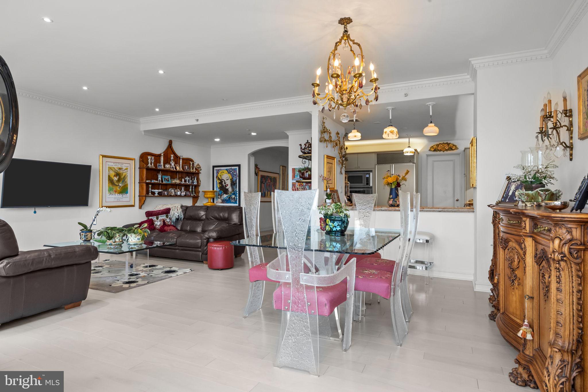 202 West Rittenhouse Square, Unit 2608 Philadelphia, PA 19103 - Photo 9 of 35 a living room with furniture a chandelier and a flat screen tv