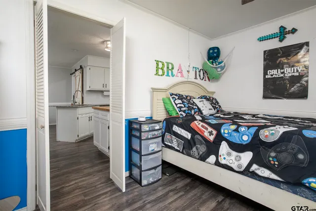 a bedroom with furniture and a wooden floor