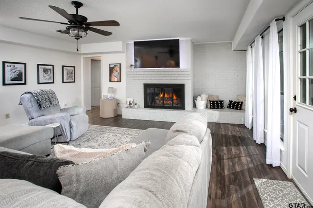 a living room with furniture and a fireplace