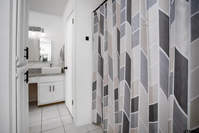a bathroom with a double vanity sink a mirror and a shower