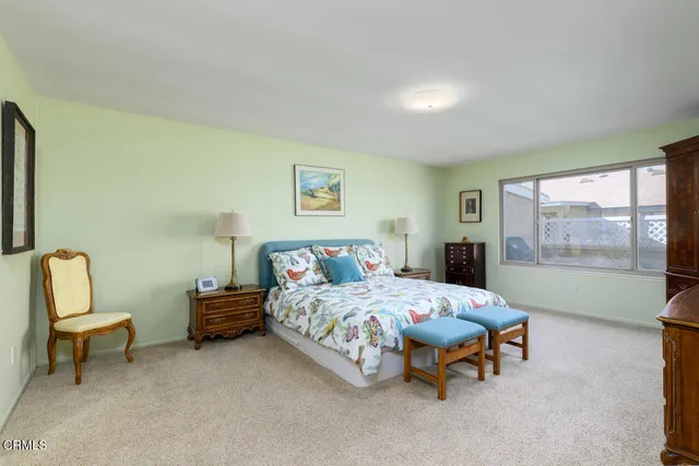 a bedroom with a bed chair and window