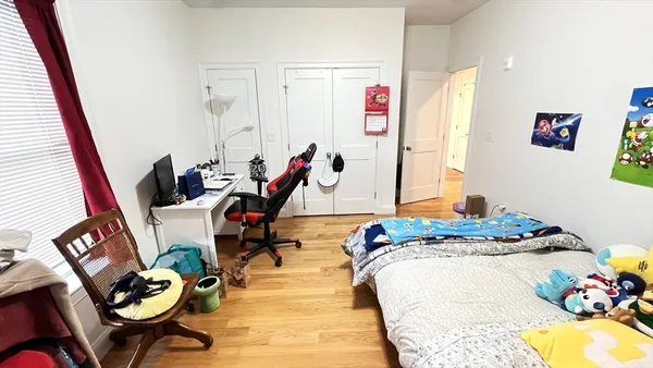 a bedroom with two beds and a window