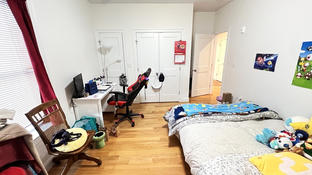 489 Main Street, Unit A Stoneham, MA 02180 - Photo 11 of 19 a bedroom with two beds and a window