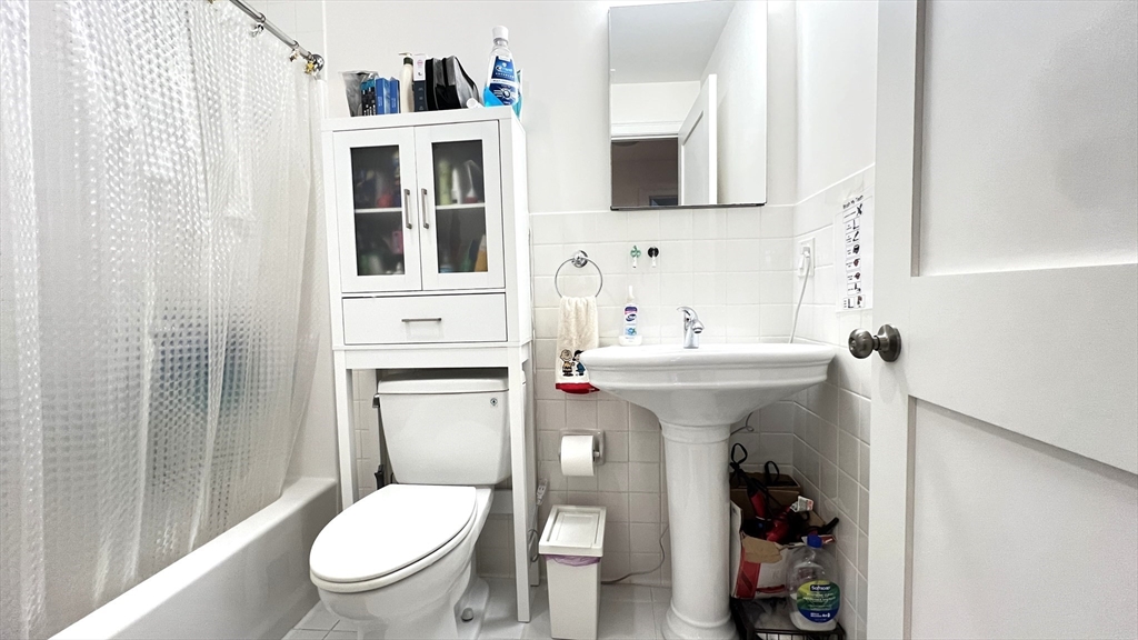 489 Main Street, Unit A Stoneham, MA 02180 - Photo 12 of 19 a bathroom with a sink toilet and shower