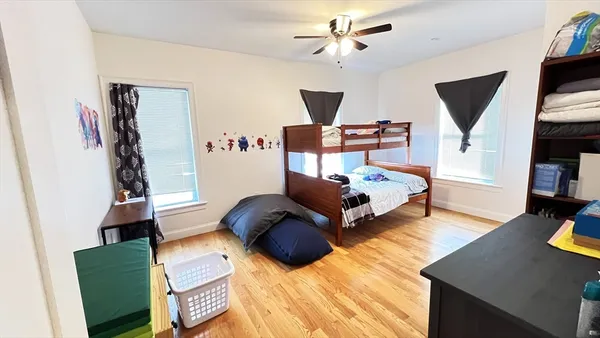 a bedroom with furniture and a wooden floor