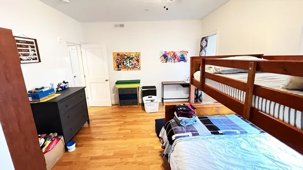 a bedroom with furniture and a flat screen tv