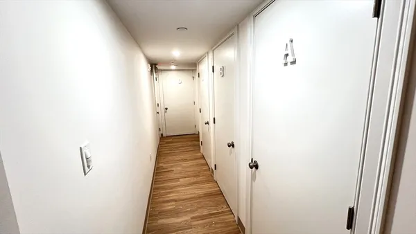 a view of a hallway with the wooden floor