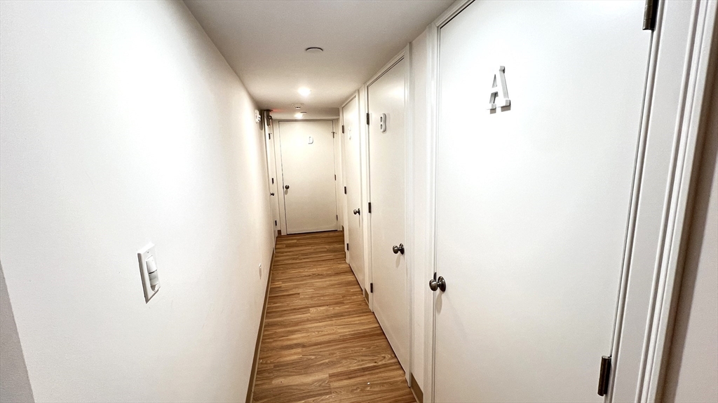 489 Main Street, Unit A Stoneham, MA 02180 - Photo 16 of 19 a view of a hallway with the wooden floor