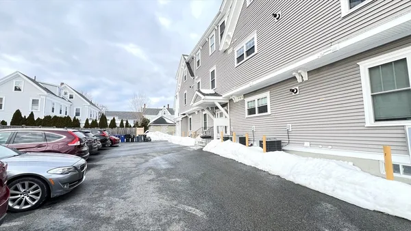 a view of a street that has couple of cars parked in front of it