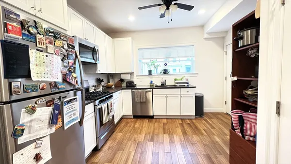 a kitchen with stainless steel appliances a refrigerator and a stove top oven