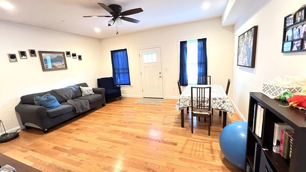 489 Main Street, Unit A Stoneham, MA 02180 - Photo 4 of 19 a living room with furniture and a flat screen tv