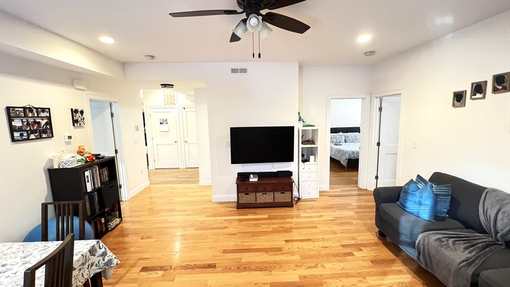 489 Main Street, Unit A Stoneham, MA 02180 - Photo 6 of 19 a living room with furniture and a flat screen tv