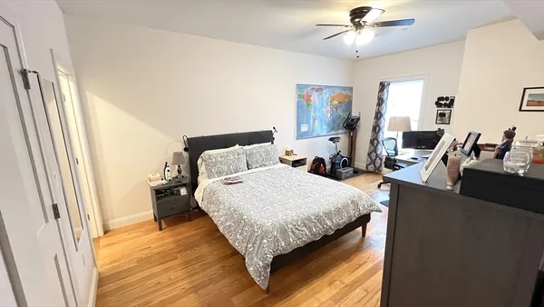 a bed sitting in a bedroom next to a window