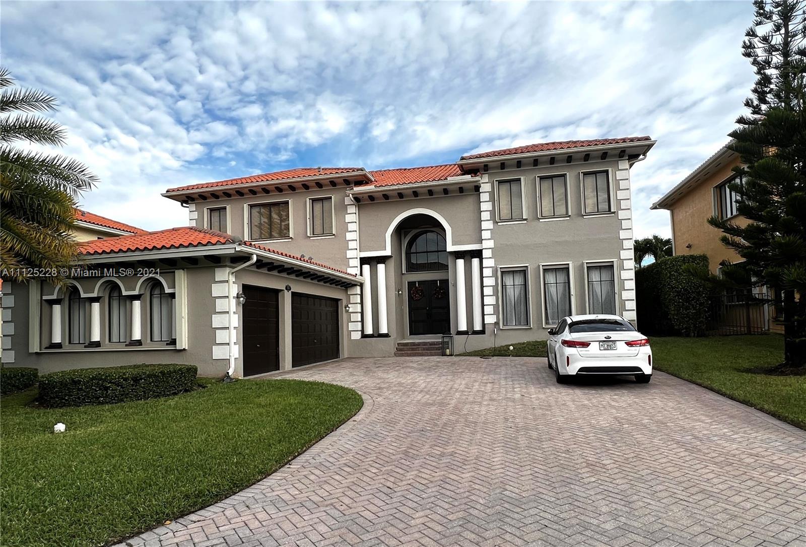 a front view of a house with a garden