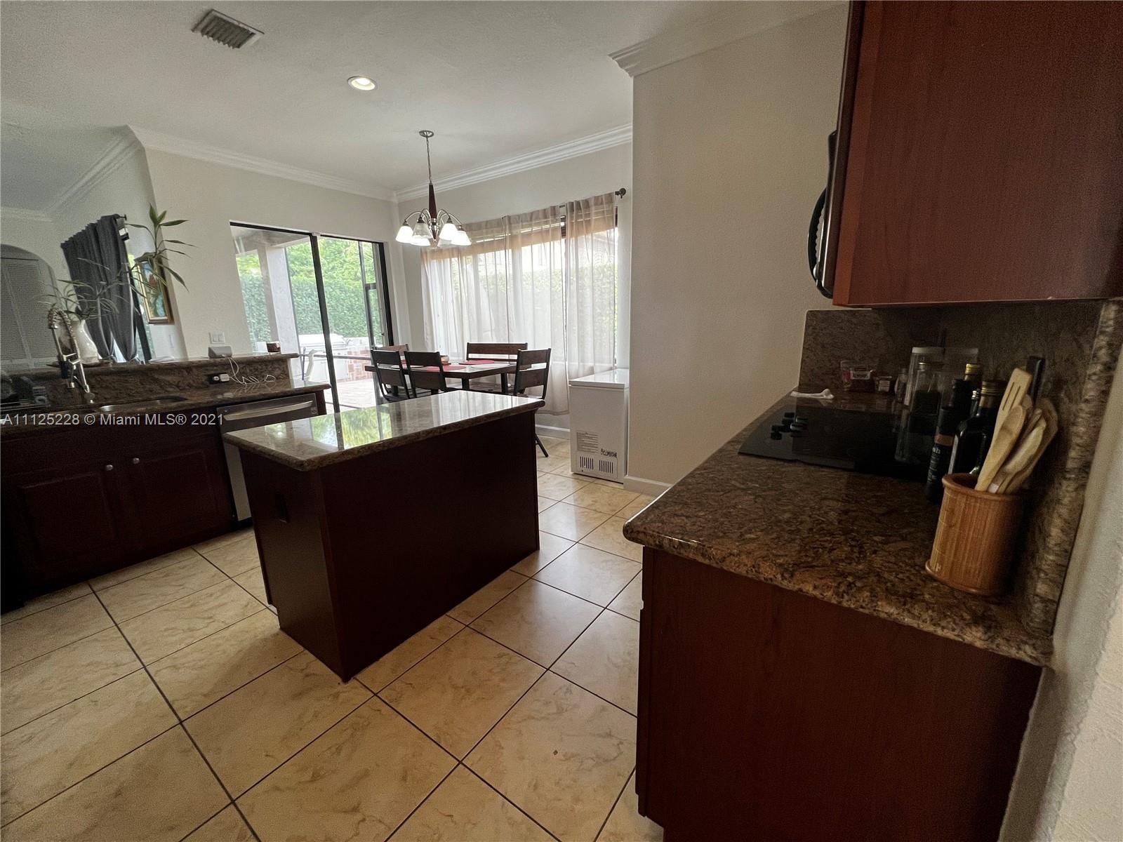 7985 Southwest 195th Street Cutler Bay, FL 33157 - Photo 11 of 16 a kitchen with granite countertop a sink and a stove