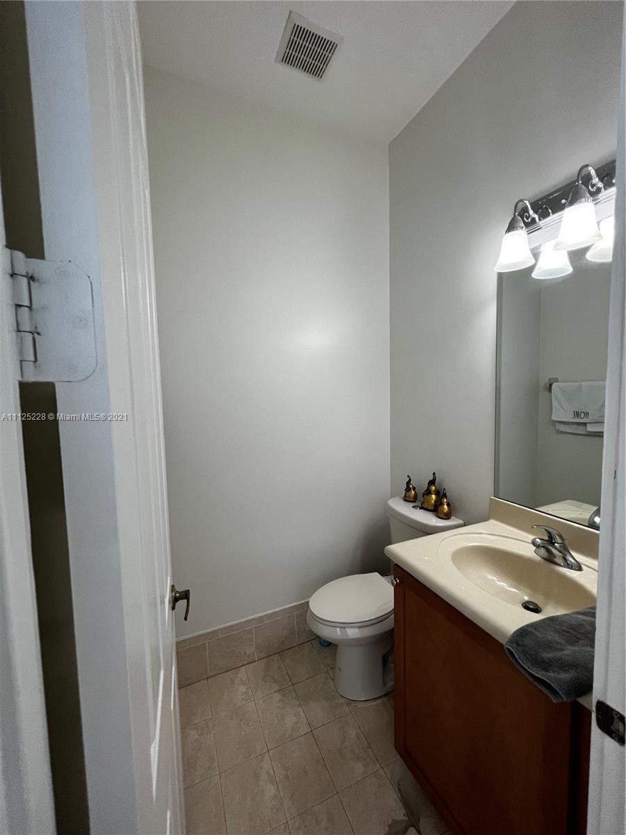 7985 Southwest 195th Street Cutler Bay, FL 33157 - Photo 12 of 16 a bathroom with a sink and a mirror