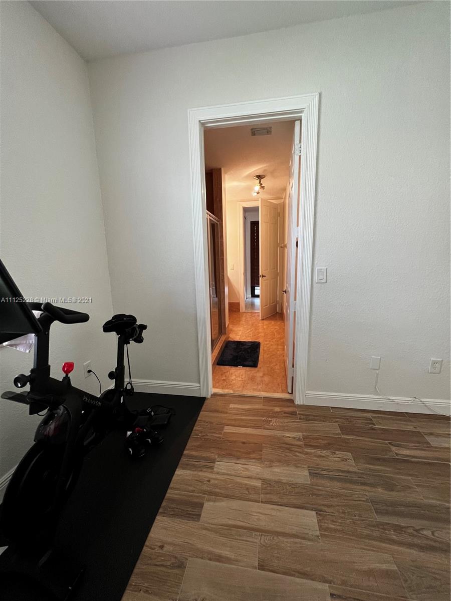 7985 Southwest 195th Street Cutler Bay, FL 33157 - Photo 15 of 16 a bedroom with a bed and wooden floor