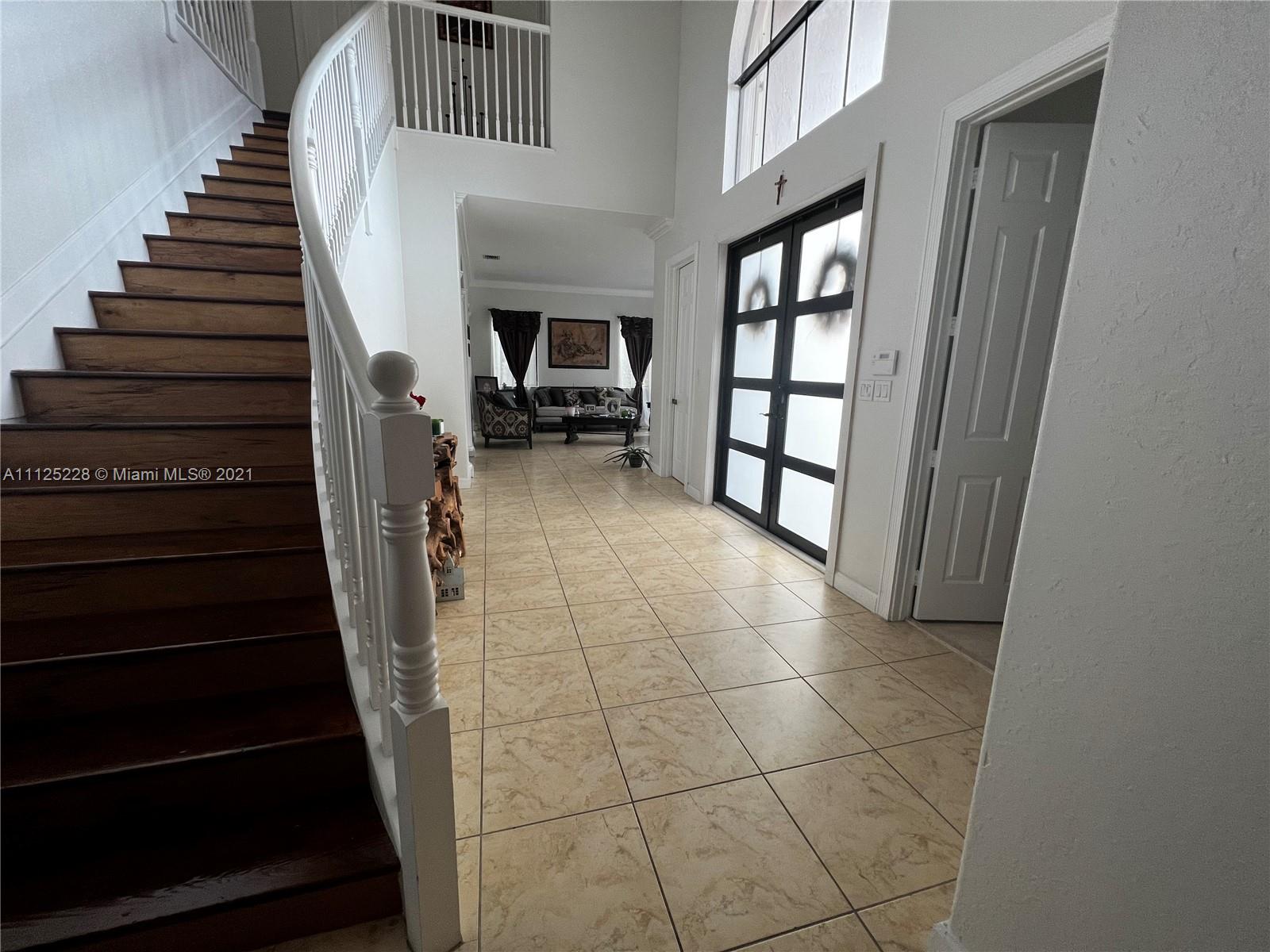 7985 Southwest 195th Street Cutler Bay, FL 33157 - Photo 5 of 16 a view of entryway and hall with wooden floor